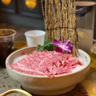 a bowl of raw beef on a table