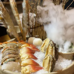 a bowl of food with shrimp and other food items