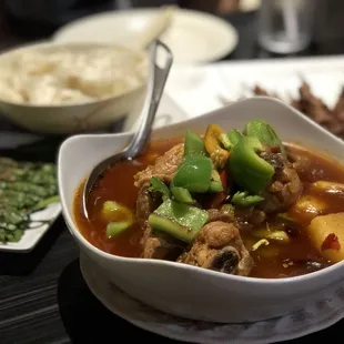 Big plate chicken, chives (left), and lamb skewers (background)