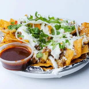 a plate of nachos with sauce