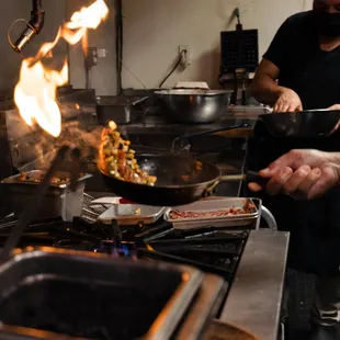 two people cooking in a kitchen