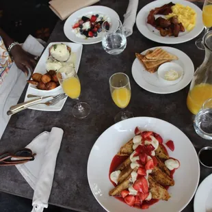 Left: eggs benedict &amp; yogurt parfait; top: egg breakfast; bottom: strawberry cheesecake french toast (a special)