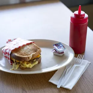 a plate with a sandwich and a drink