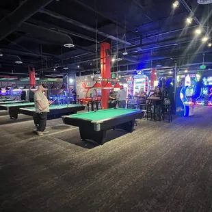 Billiard area with arcade games in the back