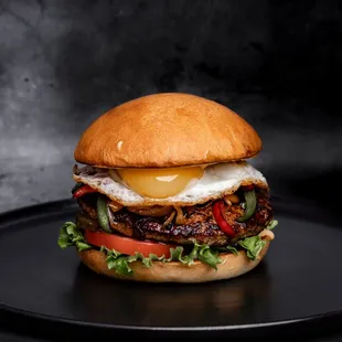 a burger on a black plate