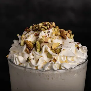 a milkshake with whipped cream and pistachios