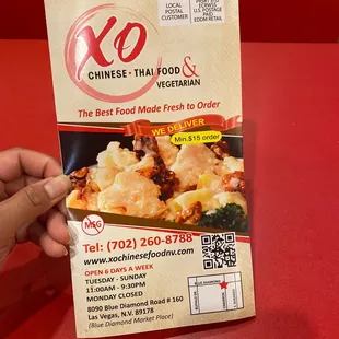 a hand holding a packet of chinese food