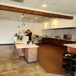 a woman standing in a coffee shop