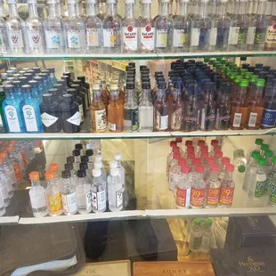 a variety of alcohol bottles in a display case