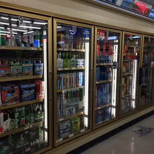 a row of beer coolers in a store
