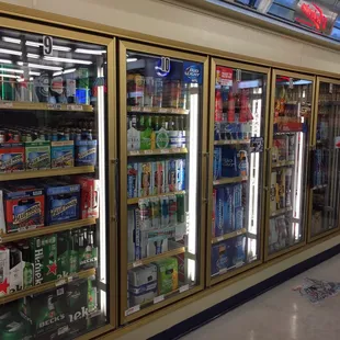 a row of beer coolers in a store