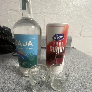 two shot glasses and a bottle of liquor