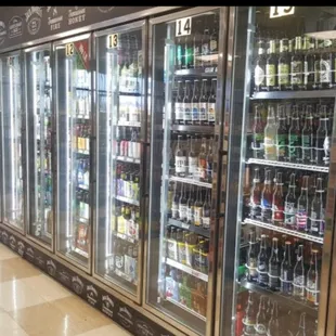 a row of beer bottles in a cooler