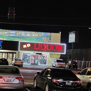 cars parked in front of a liquor shop