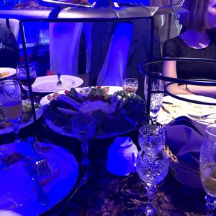 a woman sitting at a table with plates of food