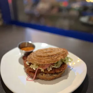 a sandwich on a plate with dipping sauce