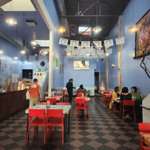 people sitting at tables in a restaurant