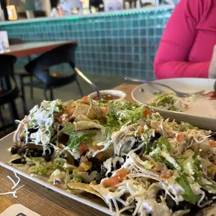 Nachos - after we started devouring them. There was lots of guac, chicken, toppings galore!