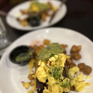 a plate of scrambled eggs and potatoes