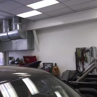 Office in the corner and vehicles to be worked on.