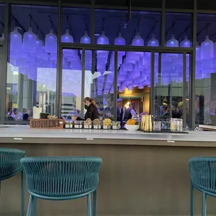 two people sitting at the bar