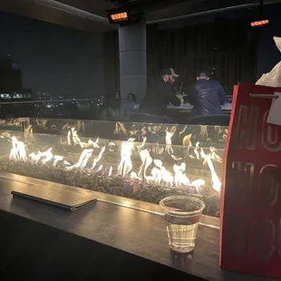 a glass of water and a fire pit