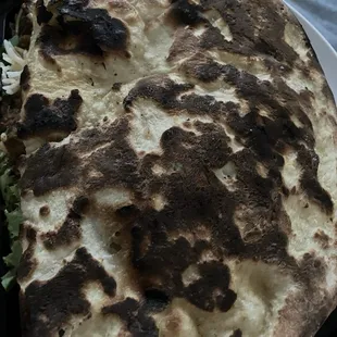 Heeee-yuge garlic naan. Not your nana&apos;s naan. More like a pizza size naan. Could eat it all day, all yay.