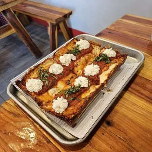 a rectangular pizza on a baking sheet