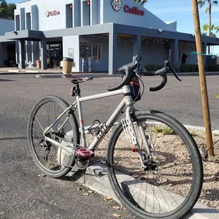 a bicycle parked in front of a coffee shop
