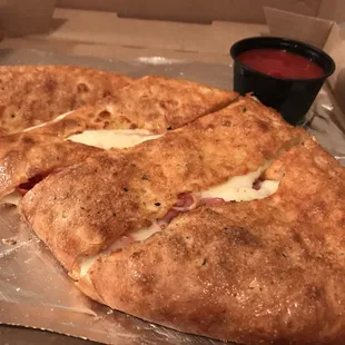 Pepperoni and ham calzone with extra cheese