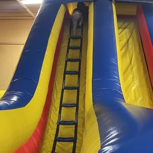 One of the jumping houses! This one has a tall ladder the kids climb up and a few long slides to go down! Super fun!
