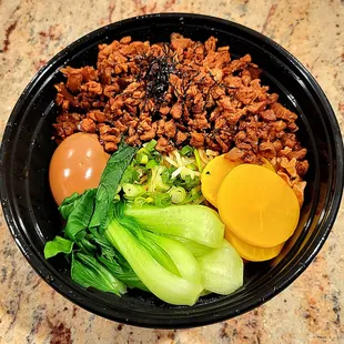 Taiwanese Minced Pork Soba had minced pork, braised egg, bok choy, bamboo shoot, oshinko, scallion, nori, fried onion, sauce, and soba.