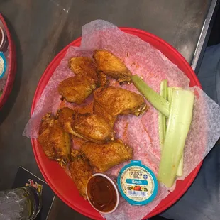 a plate of chicken wings and celery