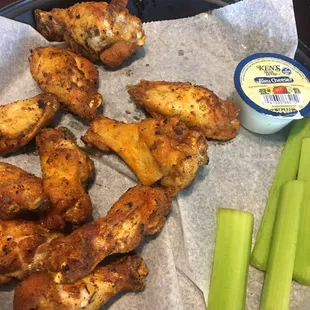 a plate of chicken wings and celery
