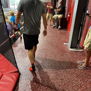 Management (man sitting) speaking with his friend.