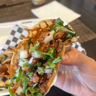 XX Taco: flour tortilla, cheese, al pastor, + bacon