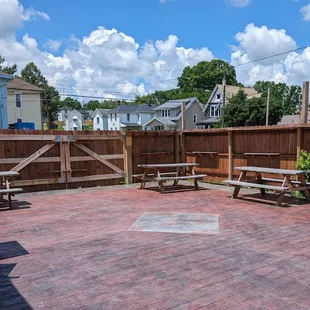Patio area (facing away from the brewery). Appreciate the shelves on the fence for beers.
