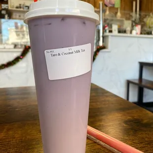 a cup of coffee with a sticker on it