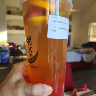 Lychee fruit tea with strawberry poppin
