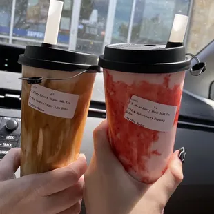 Dirty brown sugar milk with brown sugar agar boba and dirty strawberry milk with popping strawberry bobas.