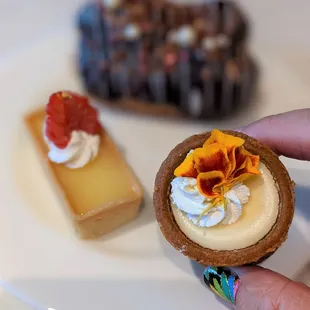 a person&apos;s hand holding a pastry