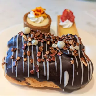 a chocolate covered donut with nuts on top