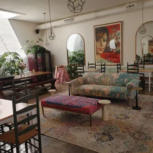 a living room with a couch, table, and chairs