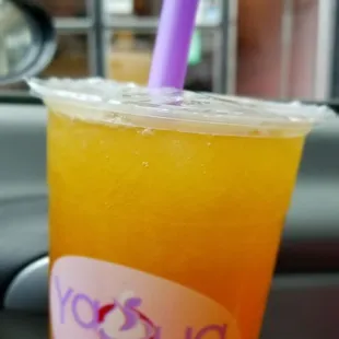 a hand holding a cup of iced yogurt