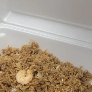 a take out container with rice and shrimp
