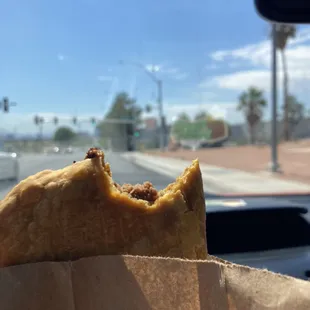 a person holding a piece of food in their hand