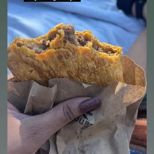 a person holding a sandwich