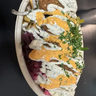Fries, falafel, pickled turnips, beets, pickles, cucumber tomato salad, sumac onions, hummus, aioli, Yaba&apos;s creamy red sauce.