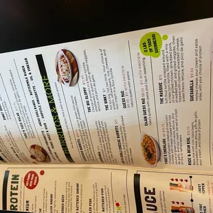 a hand holding a menu