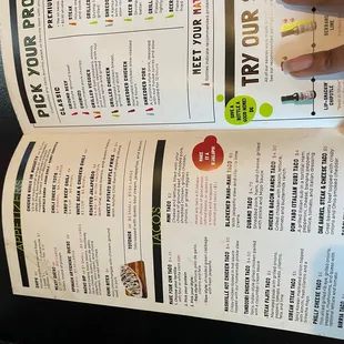 a hand holding a menu